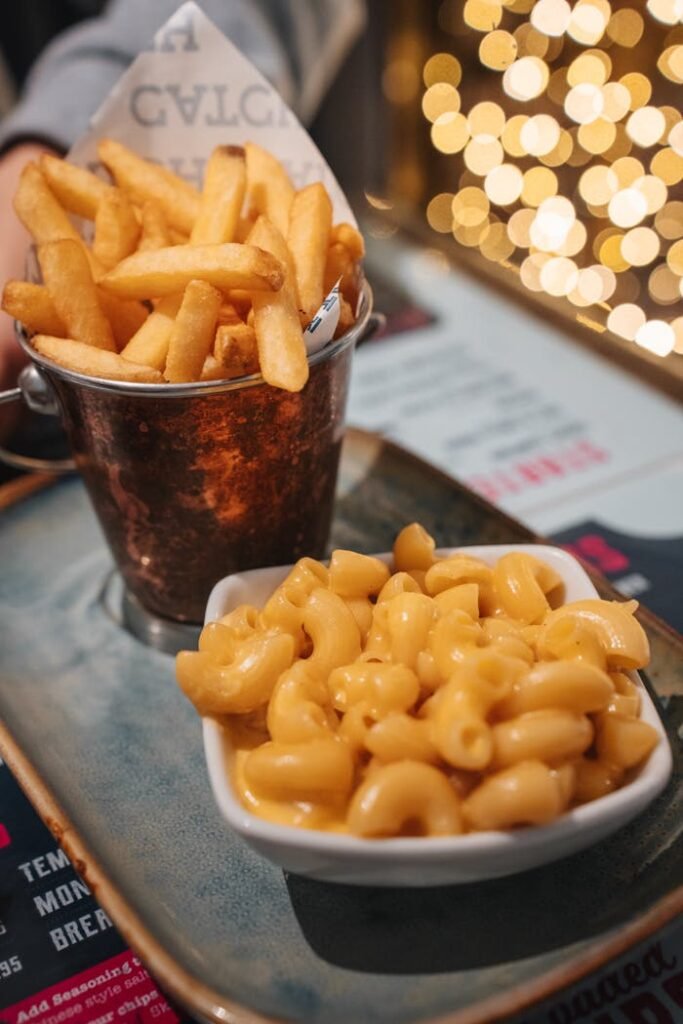 pexels-photo-34014195 Delicious mac and cheese served with golden french fries in a cozy Glasgow eatery.